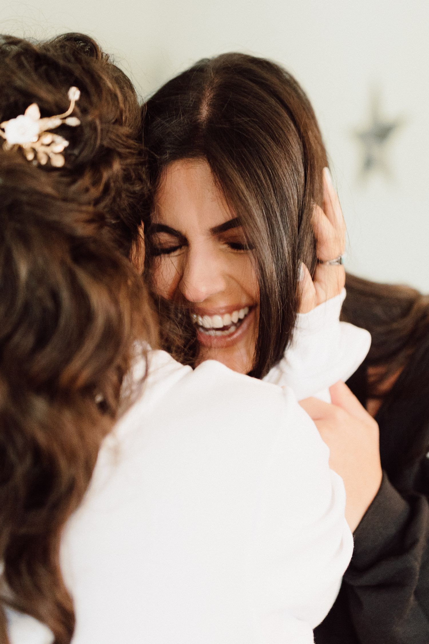 A sequence of intimate black and white photos capturing warm embraces and genuine smiles.