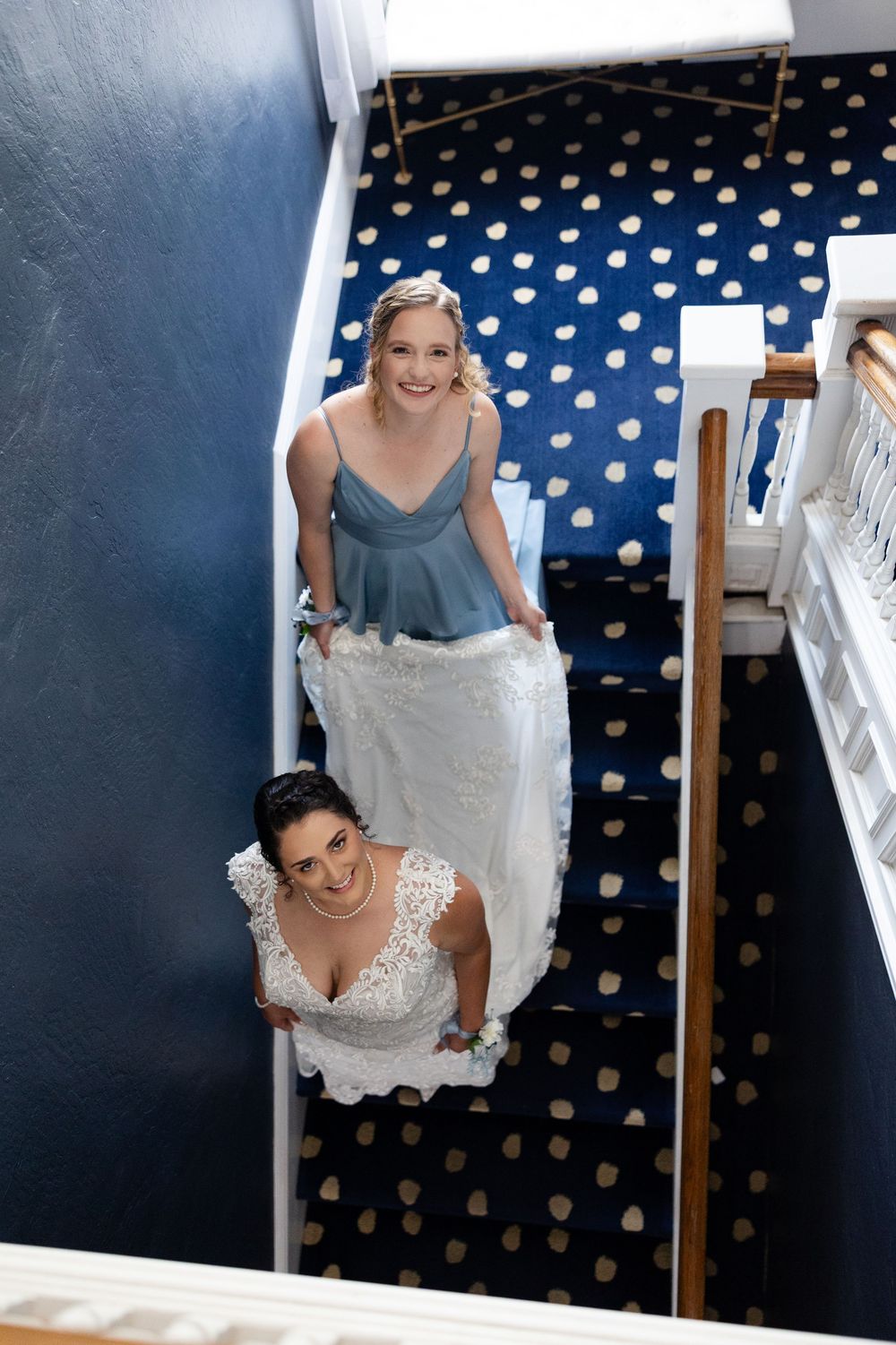 A sequence of photos showing someone trying on a white bridal dress against a navy blue wall with gold polka dots.
