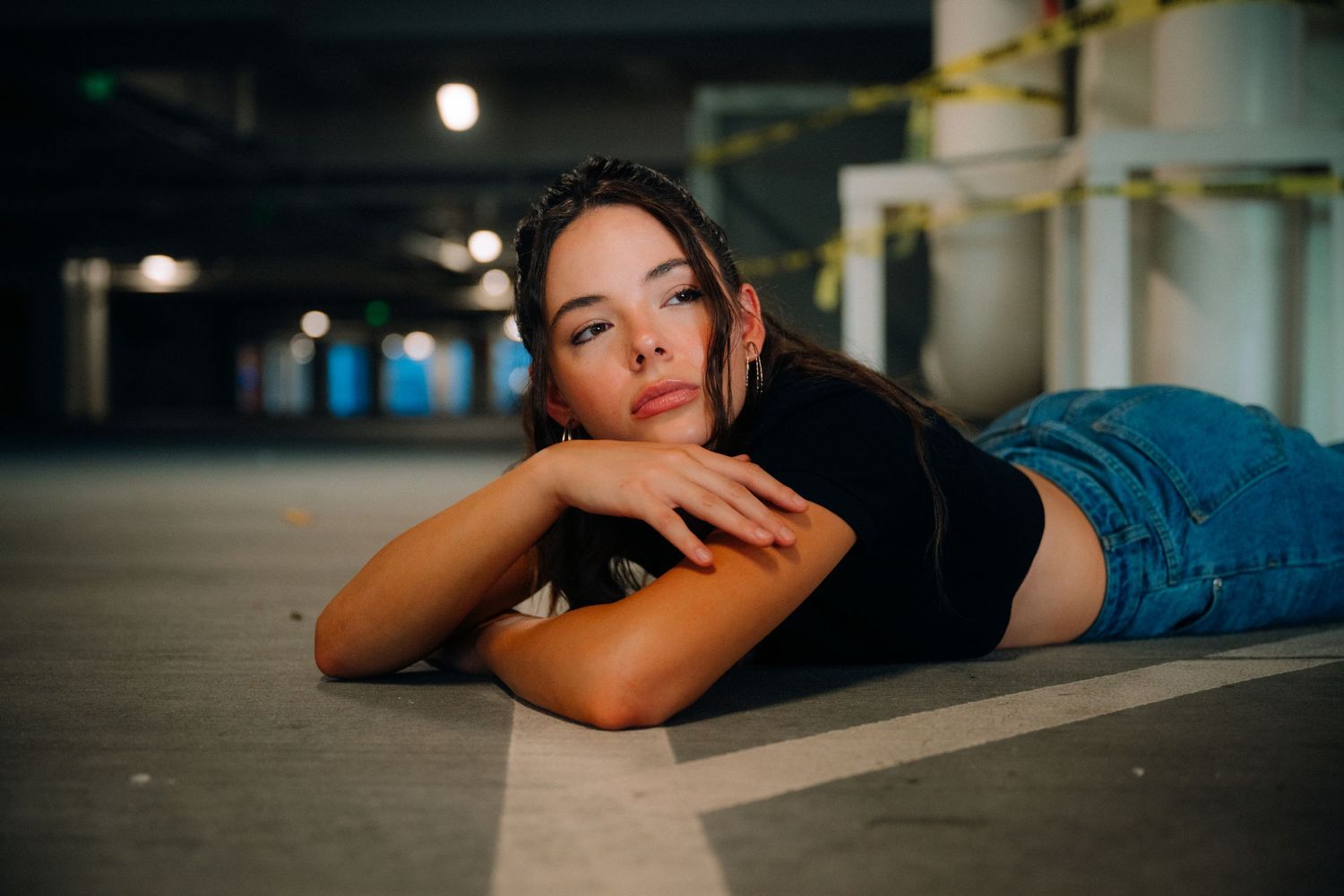 Artistic indoor portrait with moody lighting and dramatic shadows.