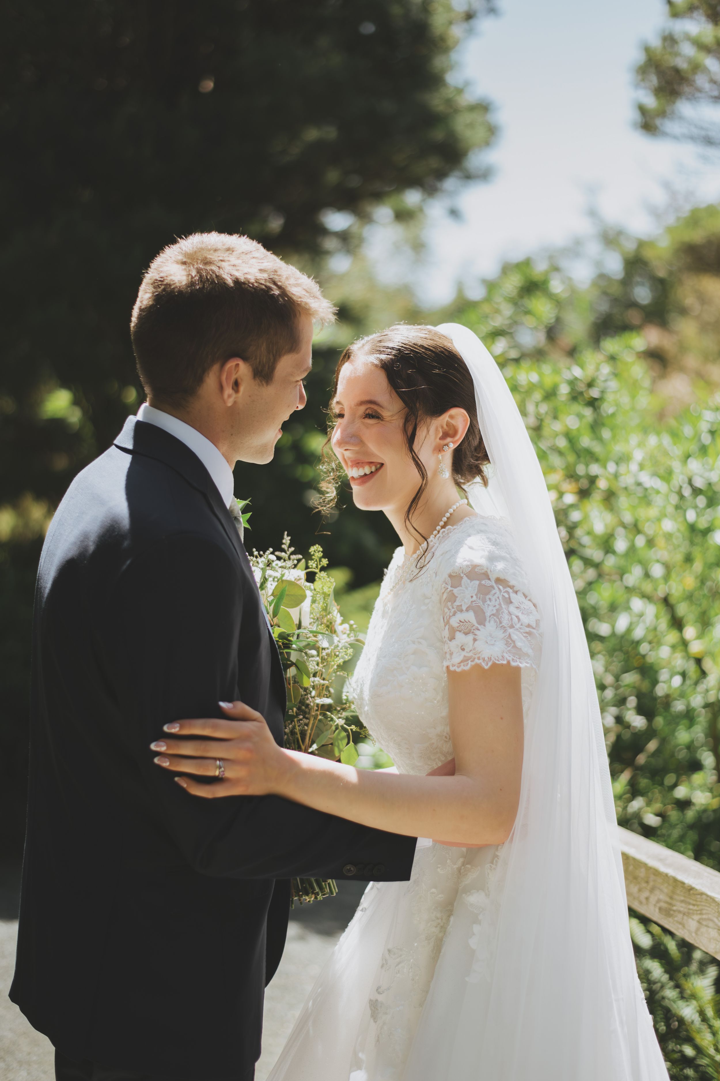 A series of romantic wedding photos shows a couple embracing outdoors in a garden setting with sunlight filtering through trees.
