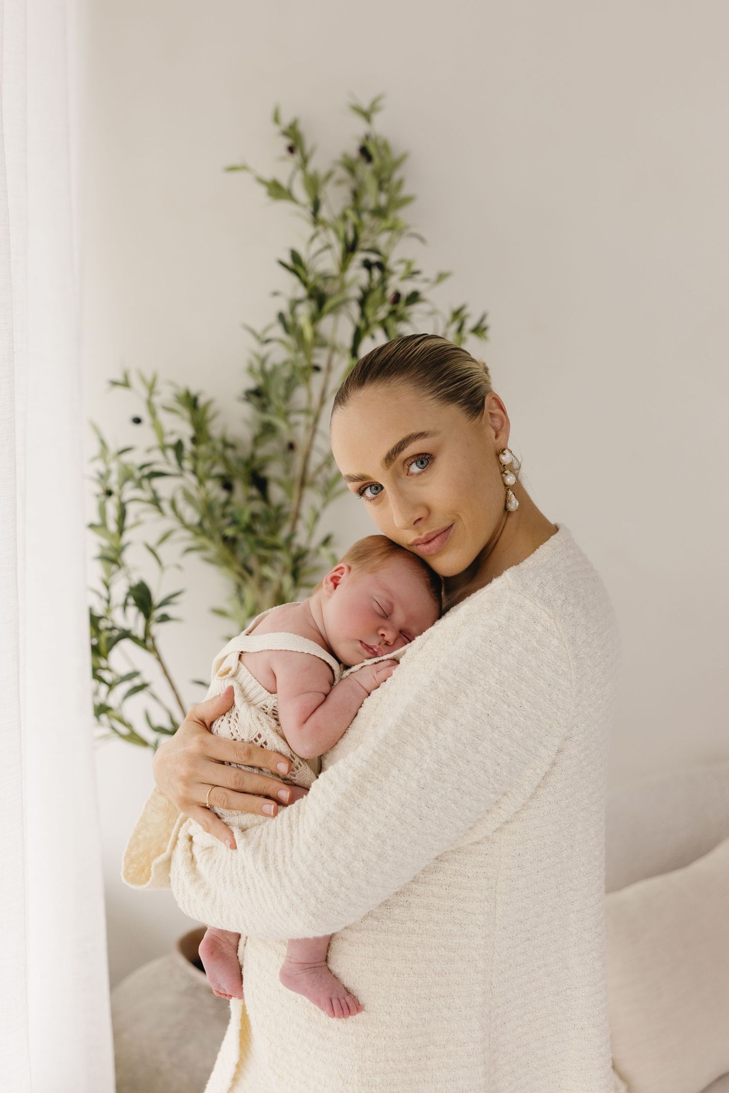 Close-up nursing newborn photos showing tender moments of breastfeeding and bonding between parent and baby.