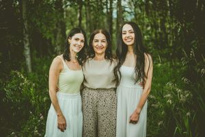 Group portrait in a wooded setting with soft natural lighting and coordinated outfits. St Albert Family Photographer