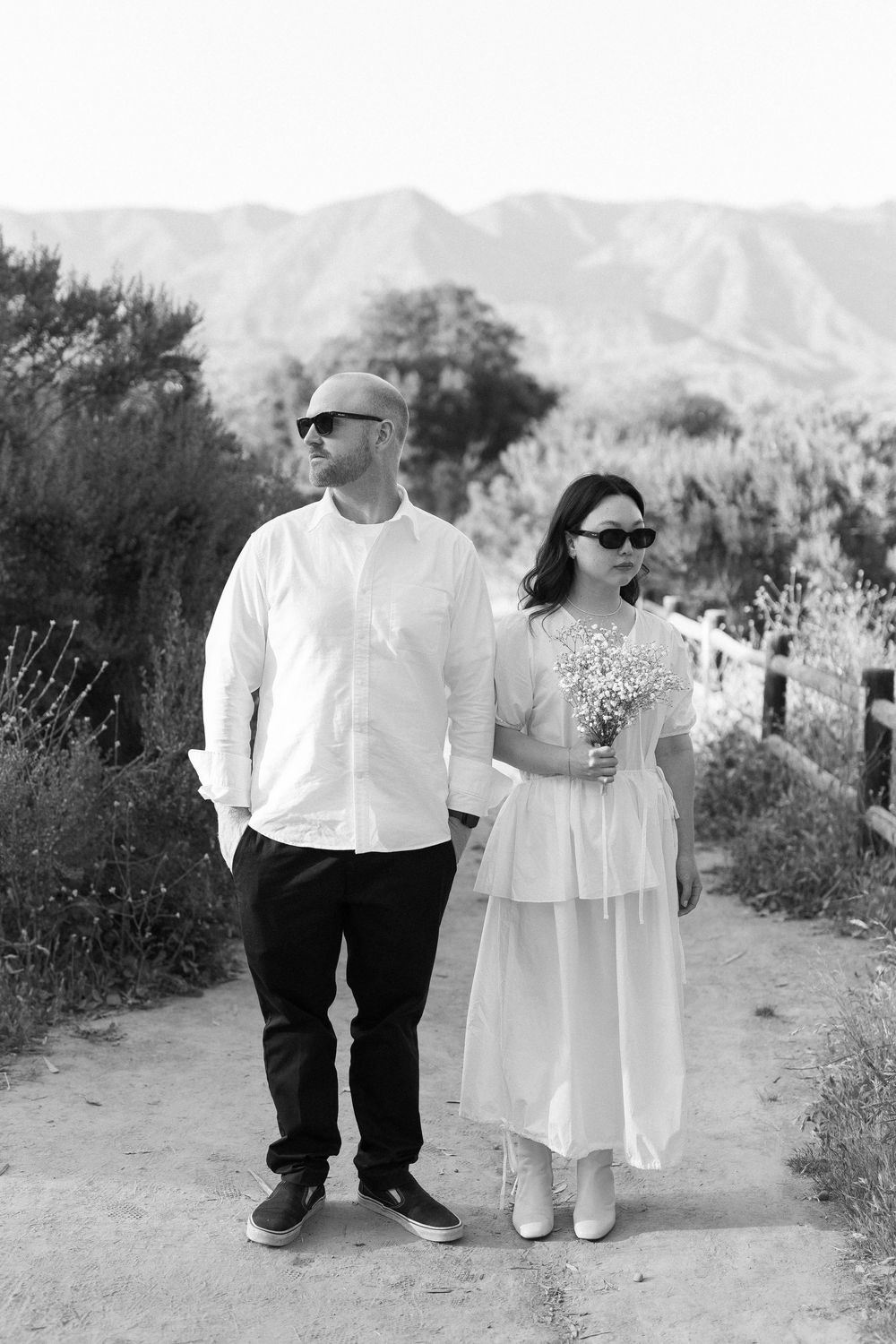 Stylish black and white portrait of couple looking cool in sunglasses at their Ojai session.