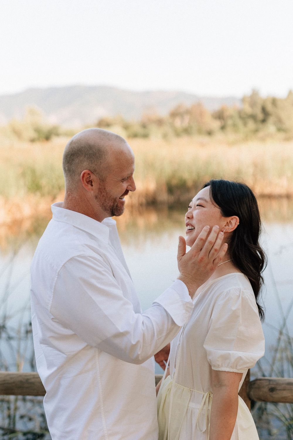 Kodak Gold film portrait of a bride and groom smiling lovingly at each other in the Ojai countryside.