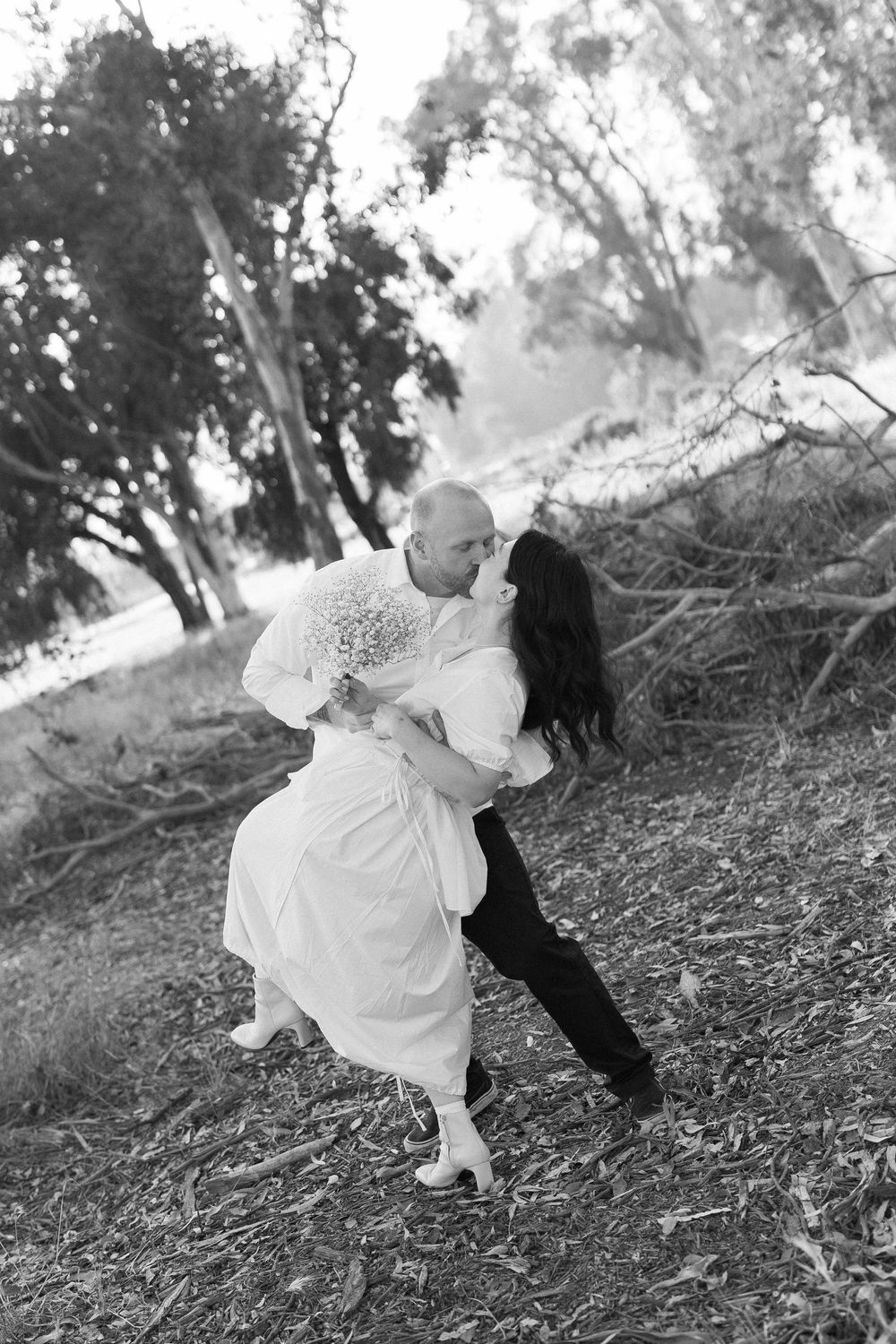 Retro-inspired black and white film photo with a stylish couple dancing in an Ojai field.