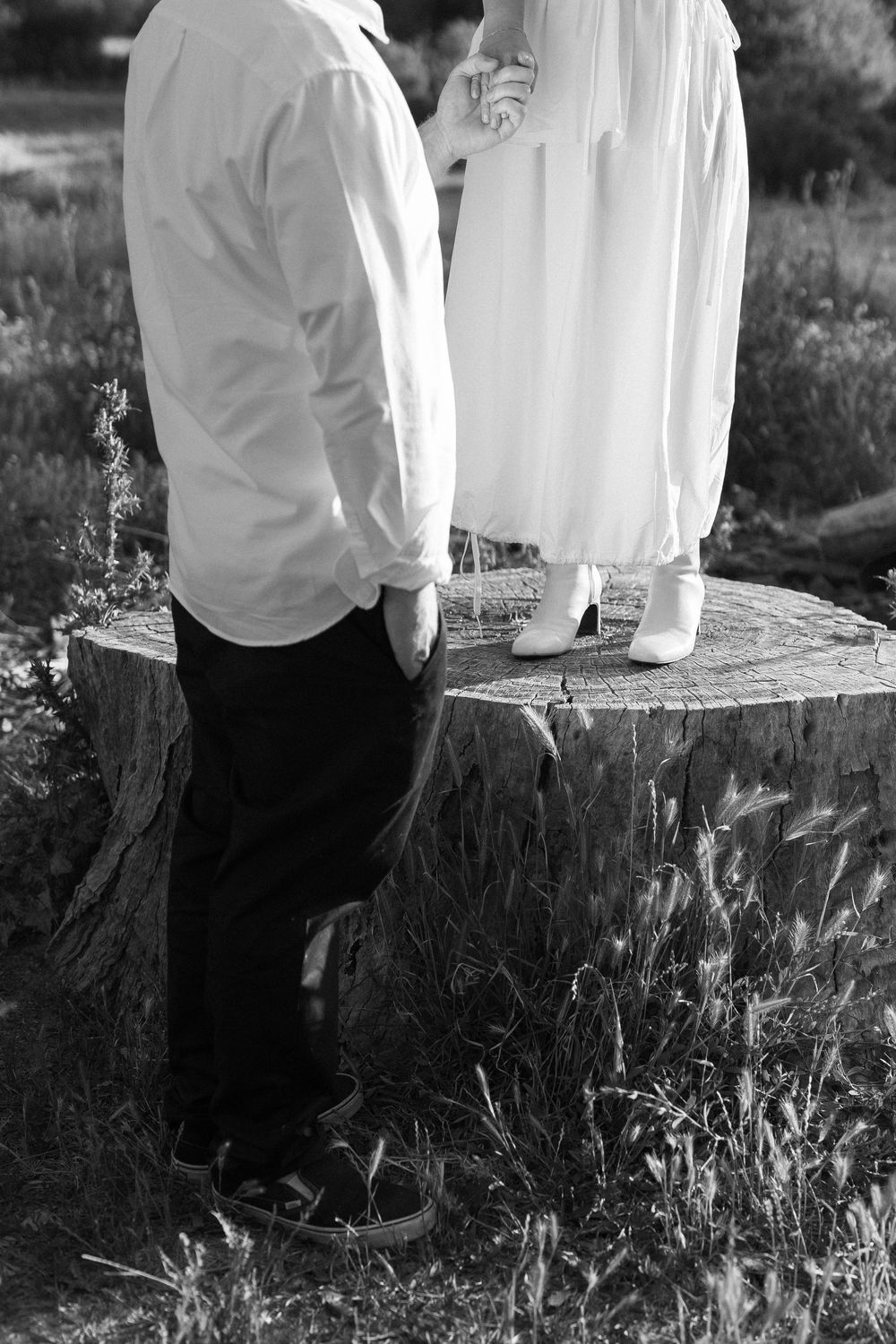 Dreamy black and white film photo of the couple walking through the meadows in Ojai Valley.