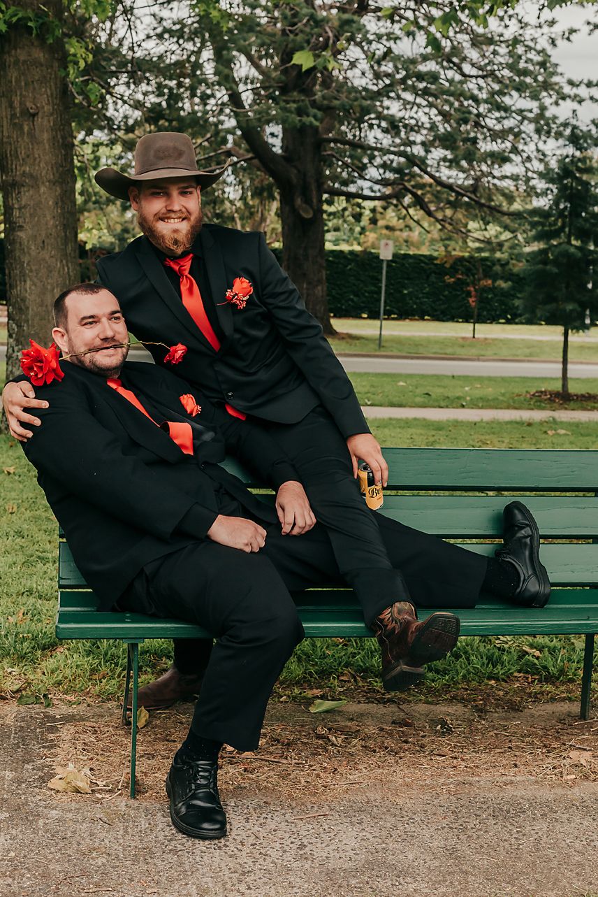 Person in black suit with red accent sits on park bench in artistic photo sequence showing progressive poses.