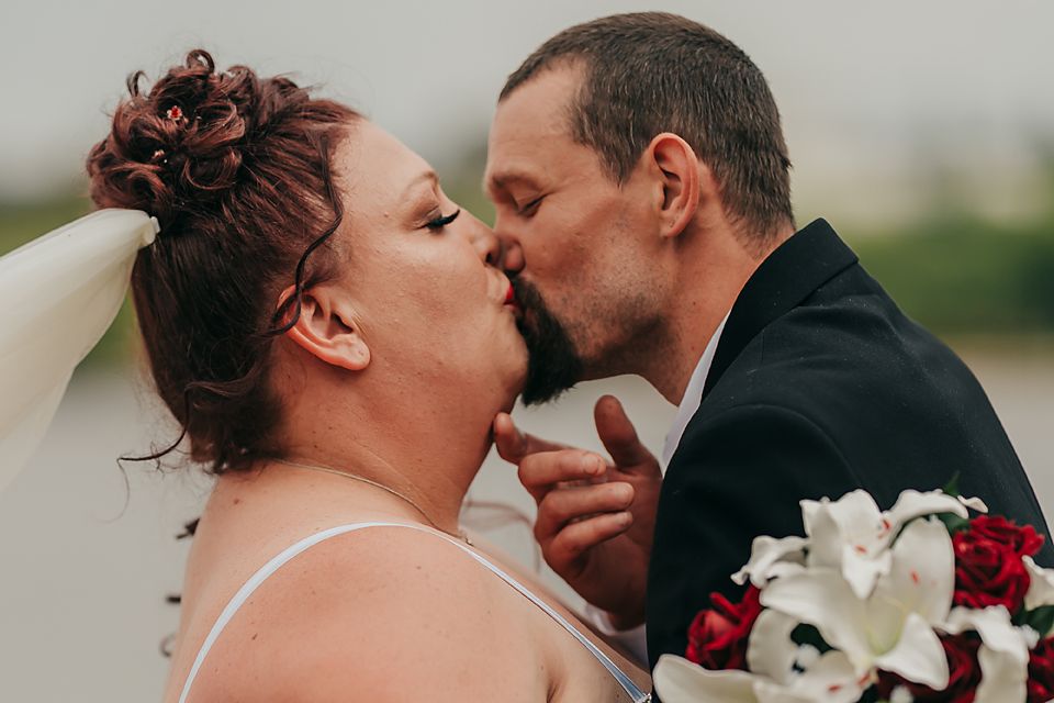 Same sex couple sharing tender kisses in a candid wedding photo sequence.