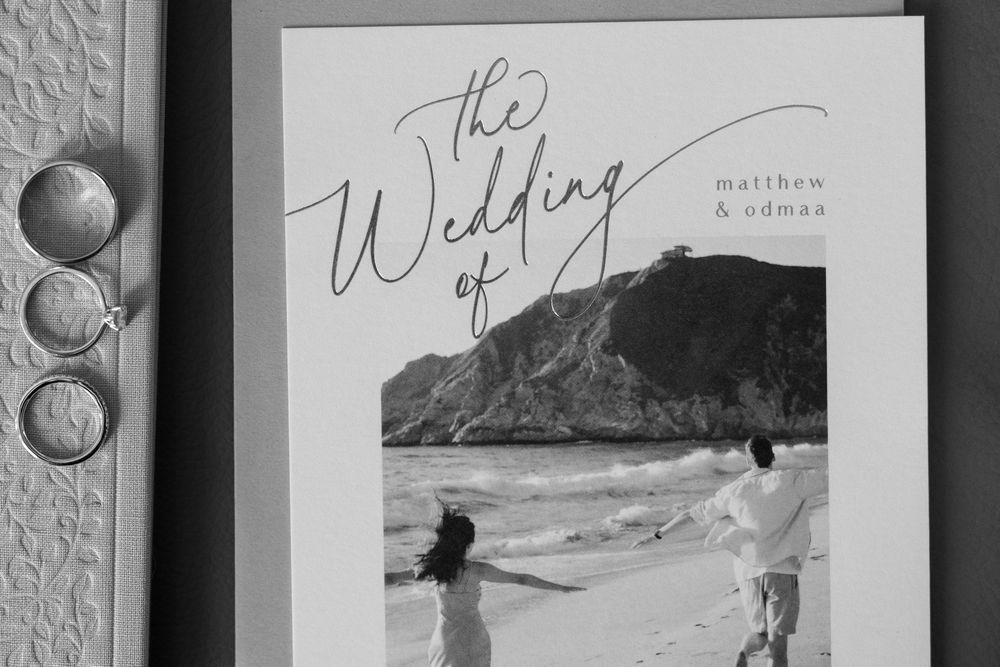 Black and white wedding stationery displaying mountain landscape imagery.