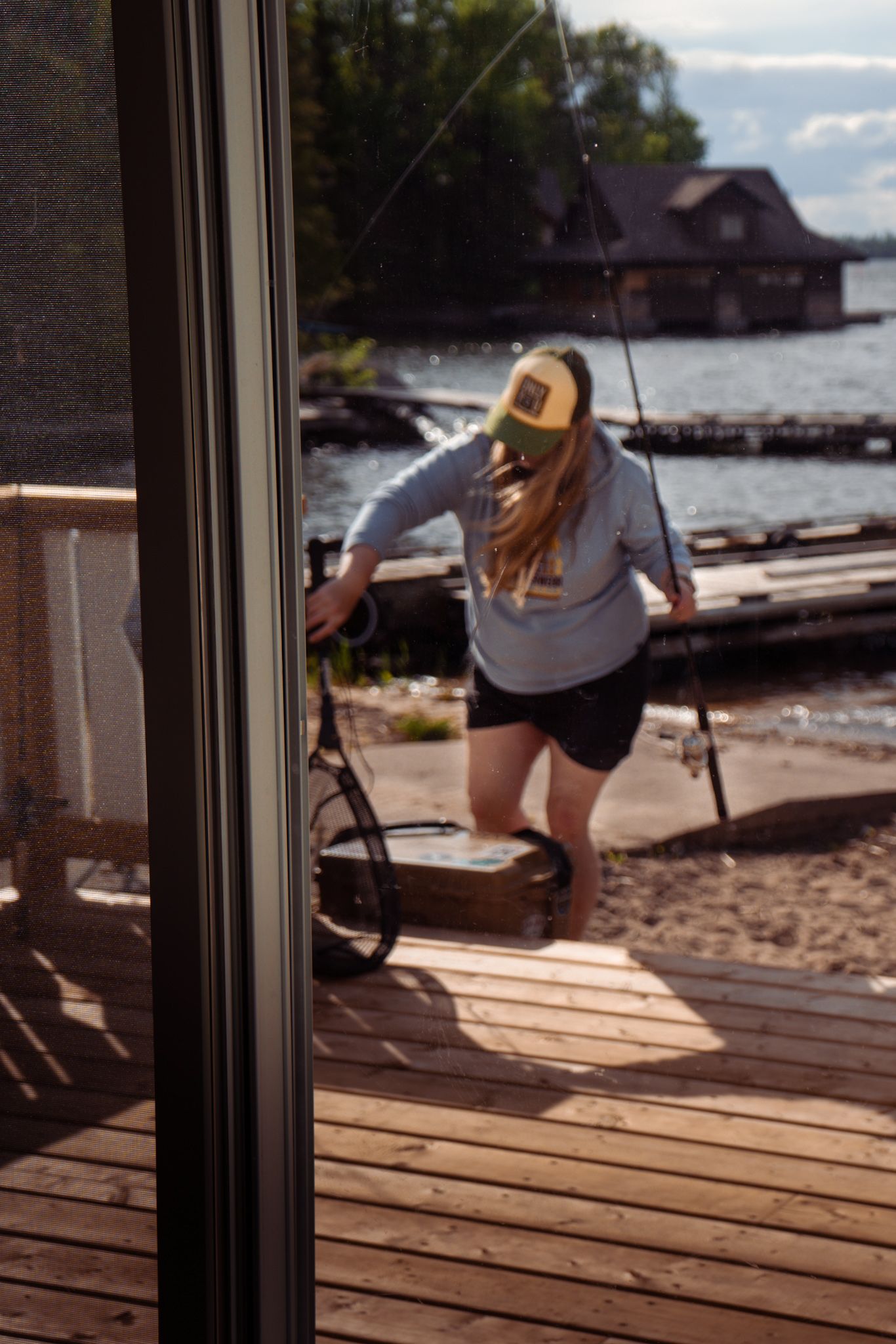 Someone enjoying a summer day on a wooden deck by the lake.