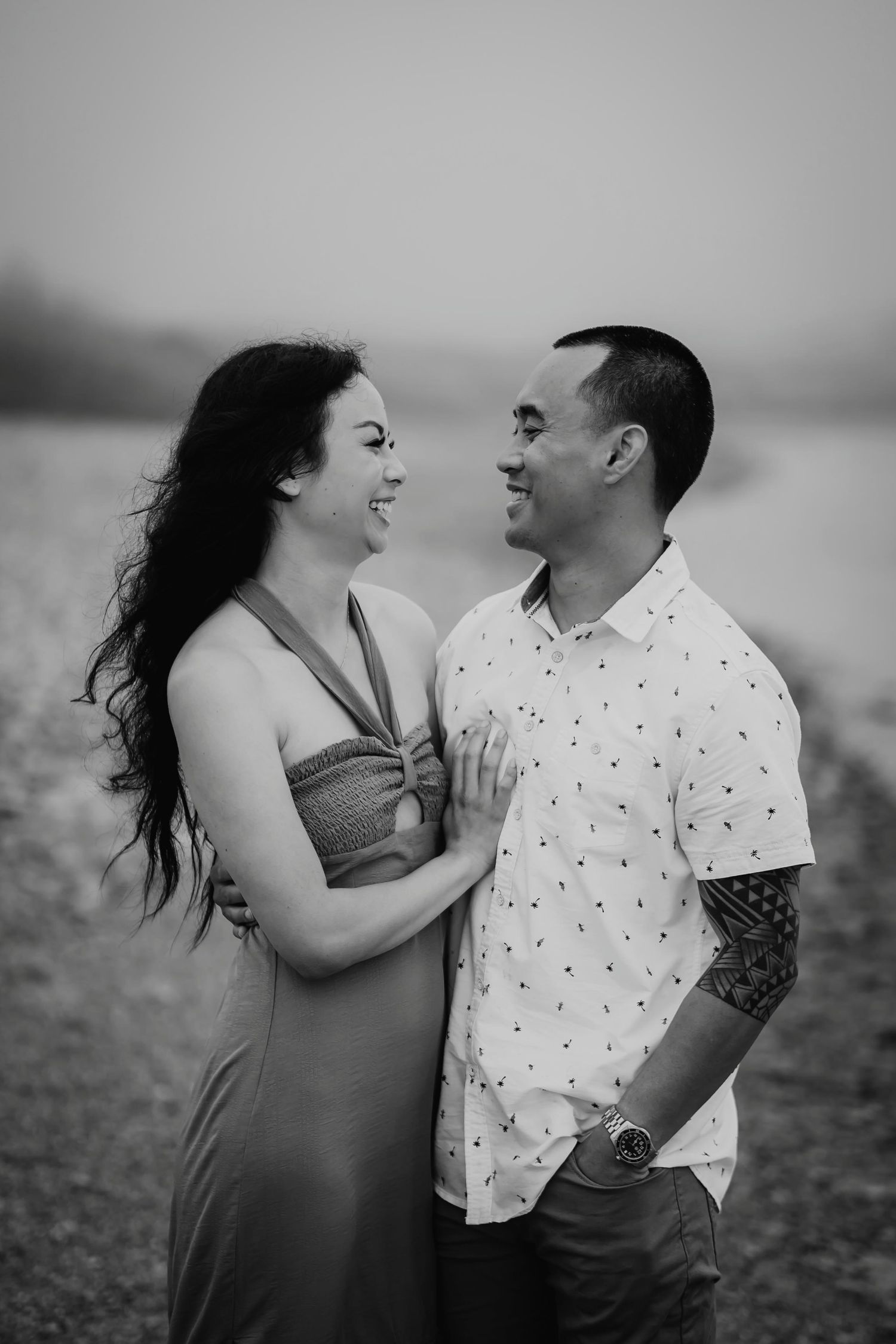 Couple looking at each other by the water — romantic Hawaii beach portrait of Jazzy and Amara by Live Tribe Media.