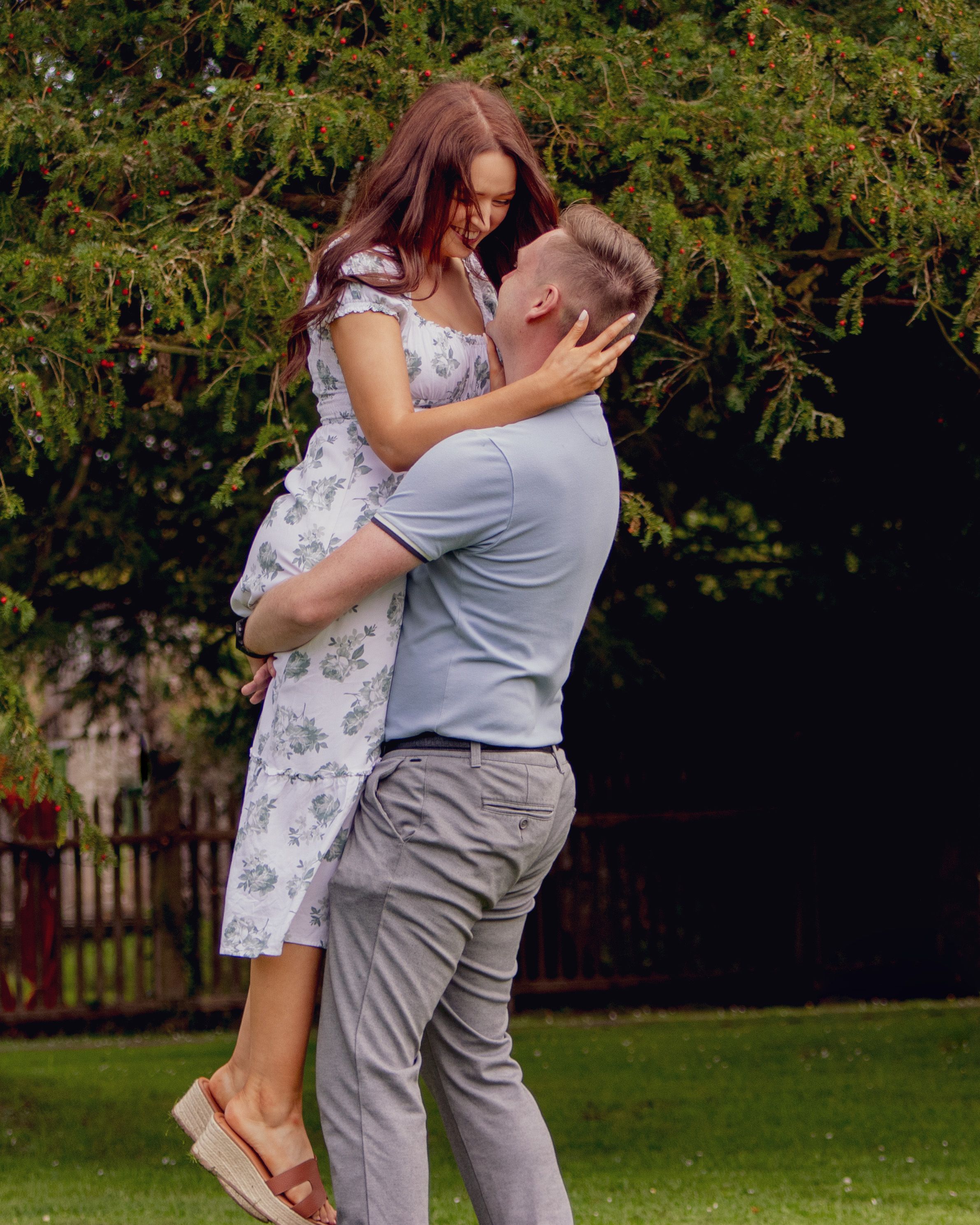 Romantic photo series showing a couple embracing in a garden setting with trees in background.