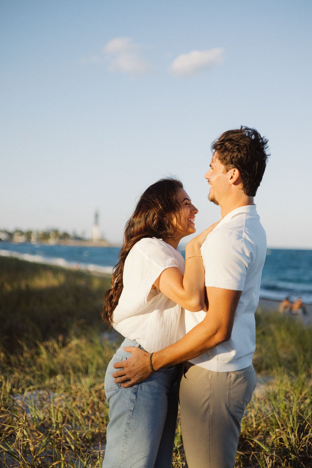 couple laughing in front of the ocean
