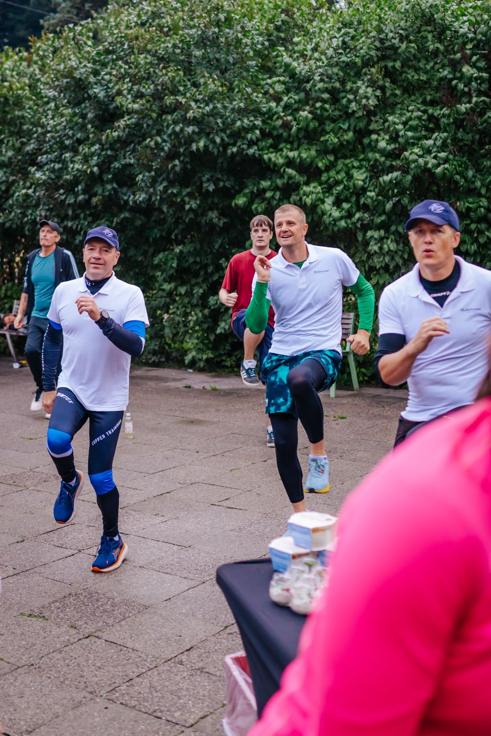 Runners in athletic gear participating in an outdoor race event.