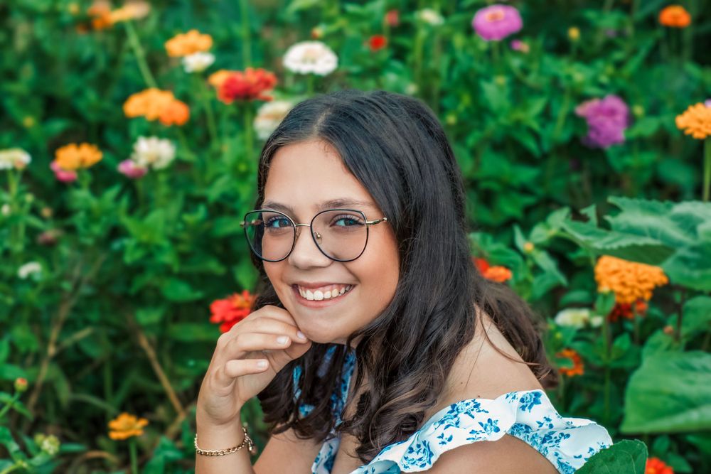 A joyful garden portrait surrounded by colorful zinnias and summer flowers.