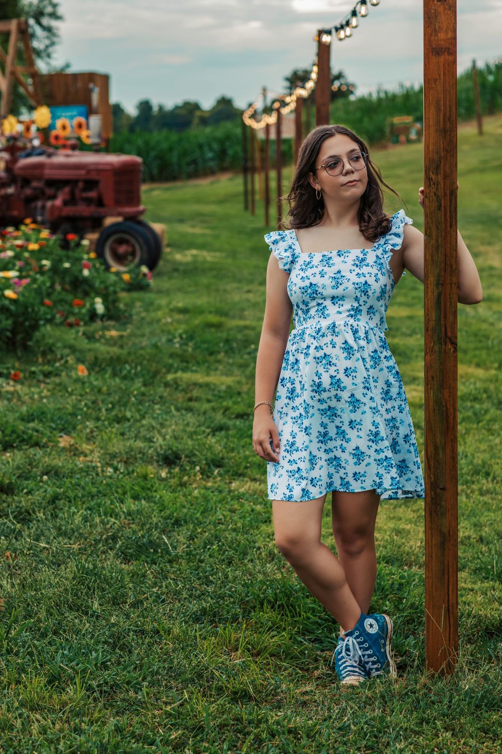 A rustic farm scene with string lights and vintage tractor in the background.