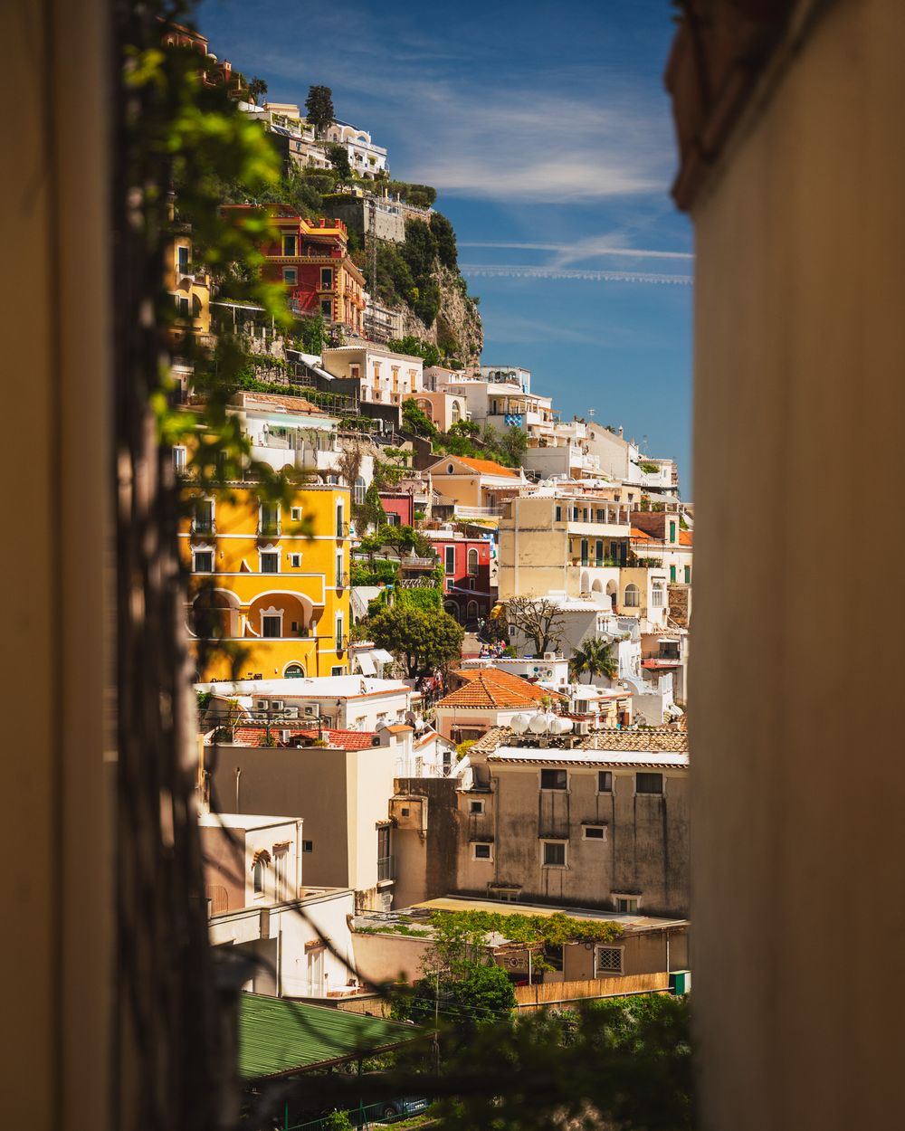 Colorful hillside houses of Positano stacked along the Amalfi Coast with Mediterranean architecture.