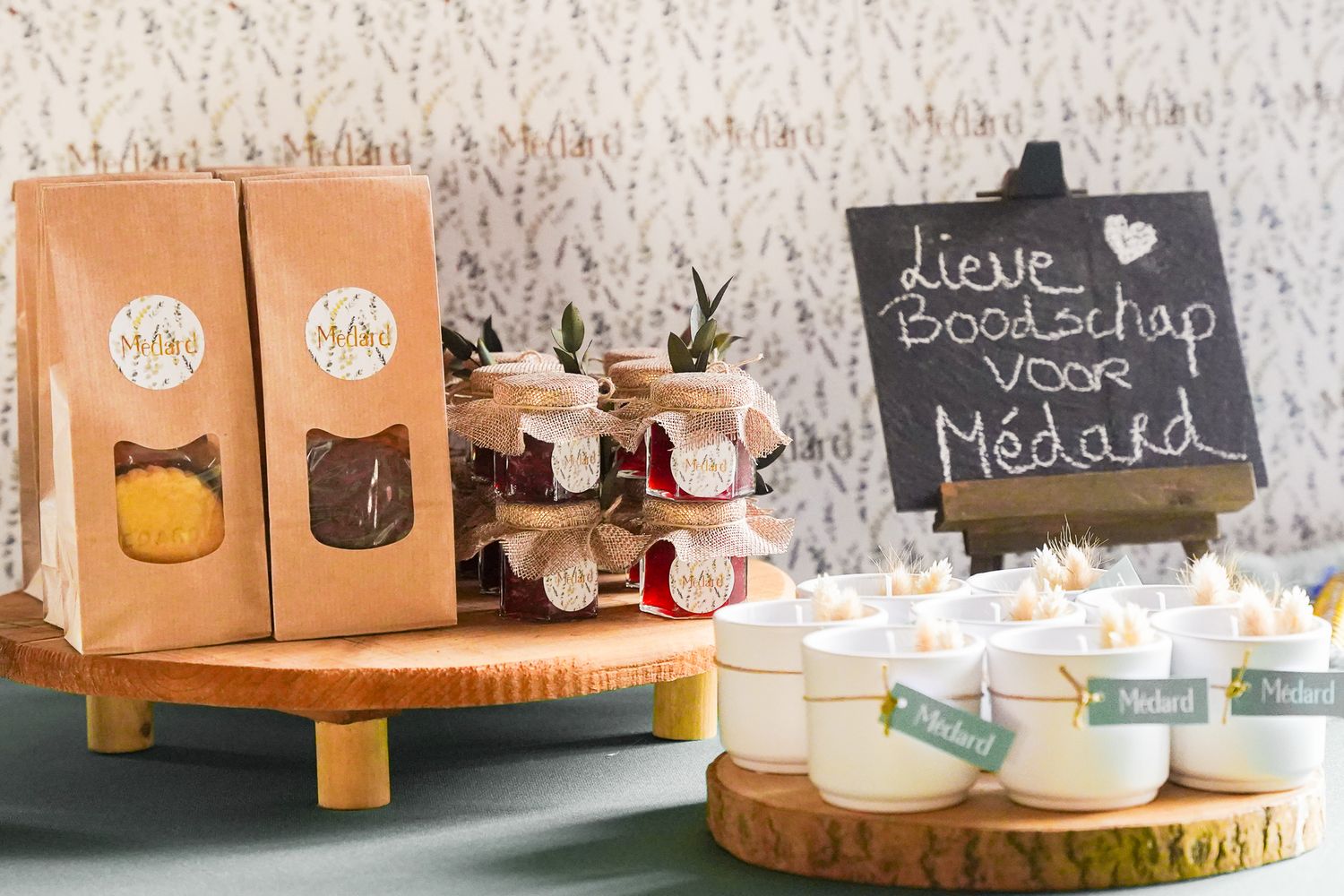 Rustic display of paper bags and glass jars on wooden platforms with chalkboard sign.