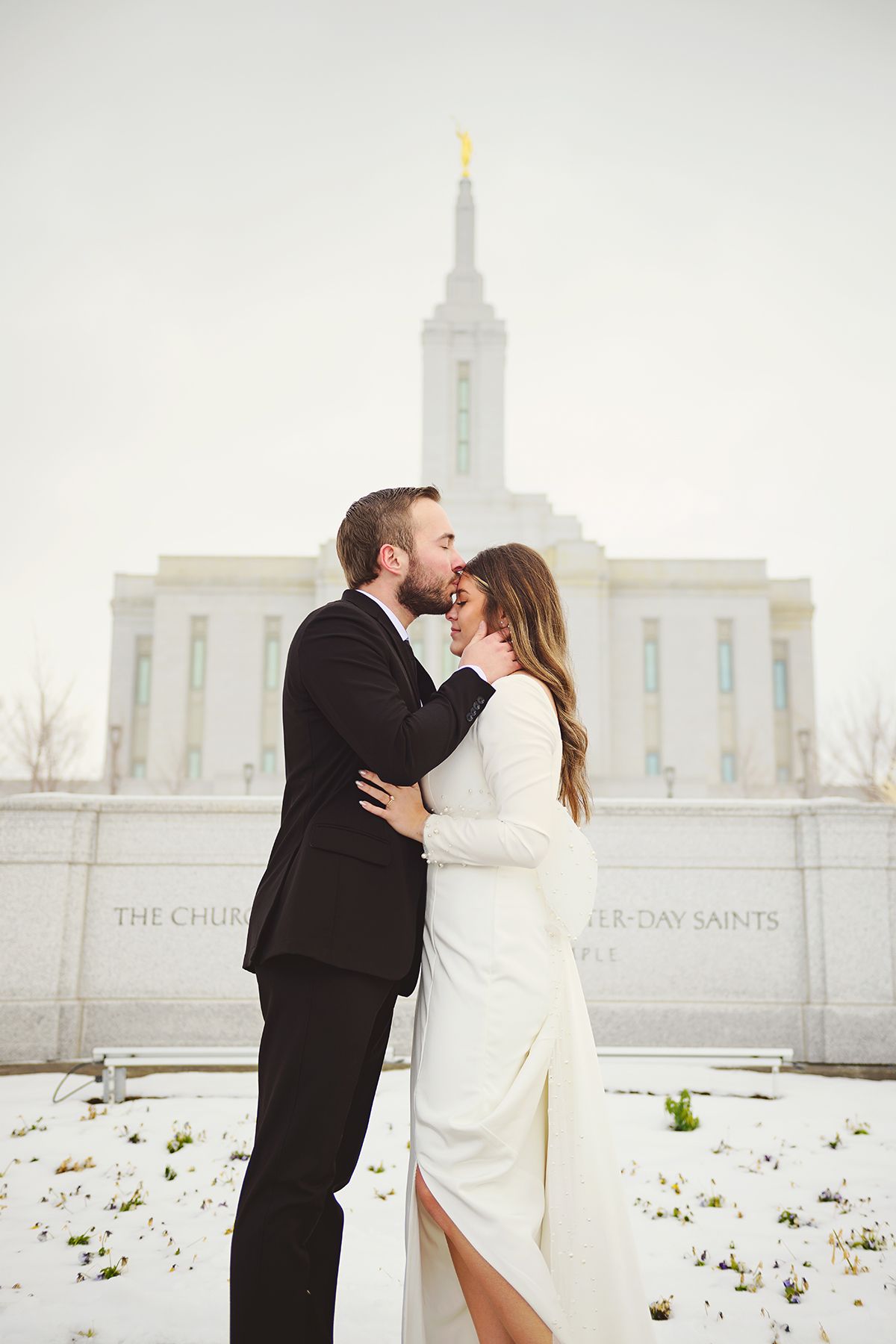 a quiet moment in front of  the snow-covered Pocatello idaho temple. Blackfoot, Idaho Falls, Pocatello Wedding photographer