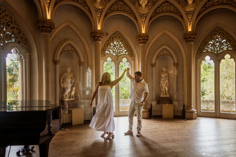 Grand interior hallway of Monserrate Palace in Sintra features ornate Gothic arches and intricate architectural details.