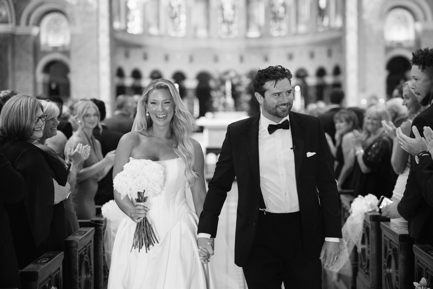 A black and white photo montage of wedding moments showing dancing, embraces and celebrations at a reception.