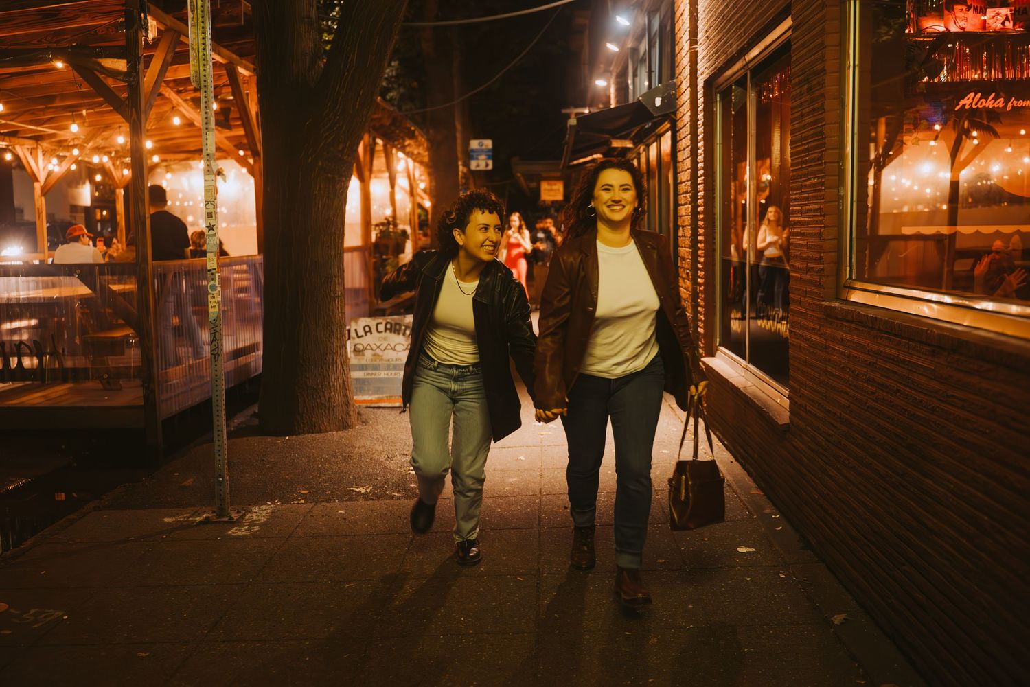 A queer couple running around Seattle under city lights.
