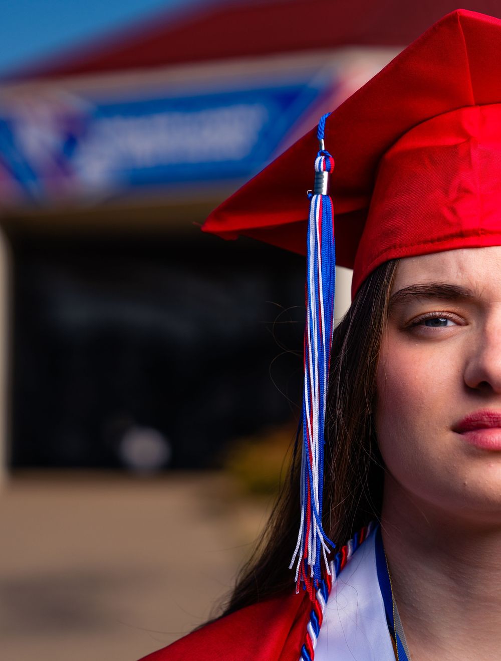 Senior portraits with cap in gown in Nelson County