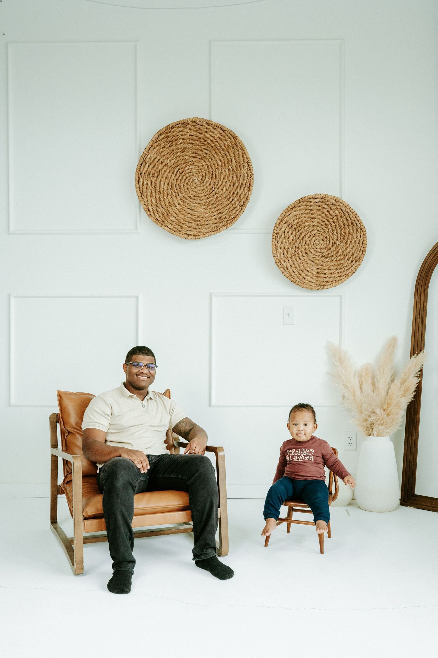 Minimalist white room with brown woven wall decor and wooden chair displaying progressive movement sequence.