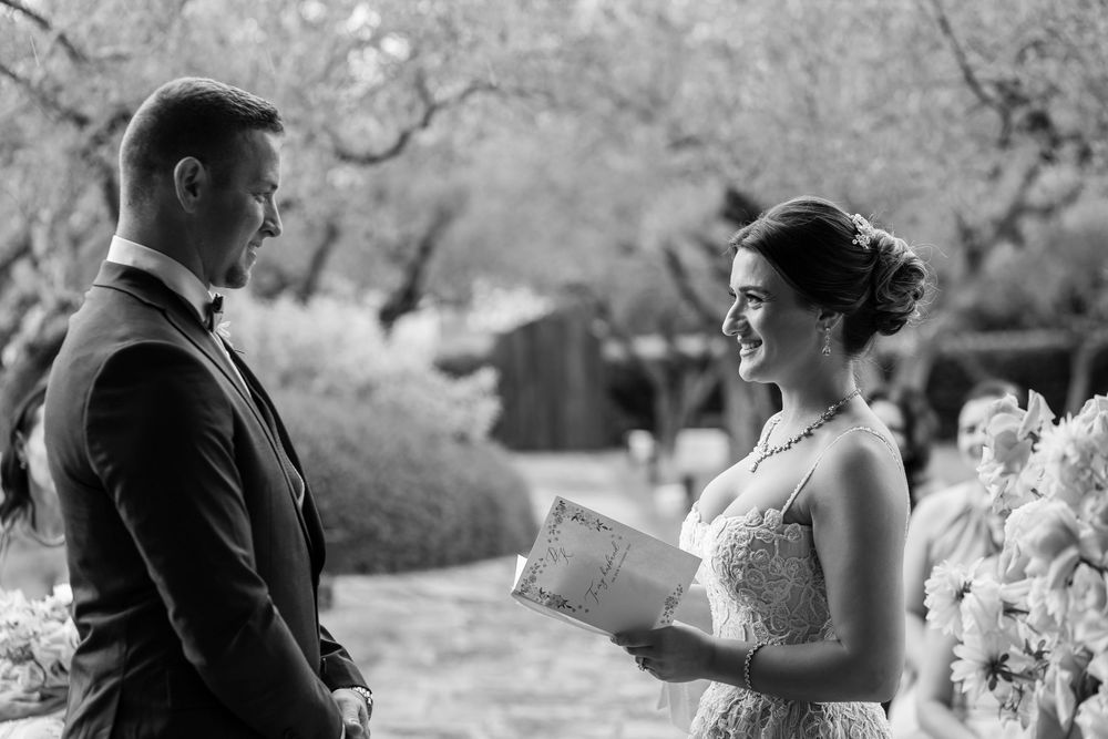 Intimate garden ceremony under olive trees at Nun Assisi Relais & Spa Museum.