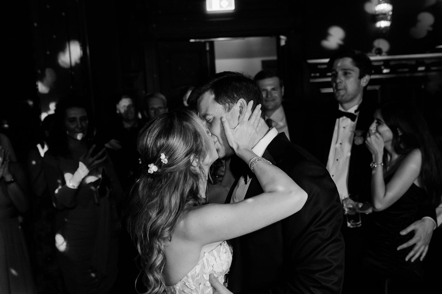 Black and white photo montage showing multiple couples dancing and embracing at what appears to be a wedding reception.