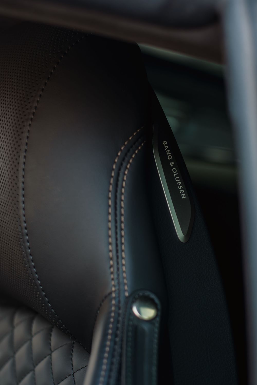 Detailed shot of premium black leather interior with contrast stitching in a luxury vehicle.