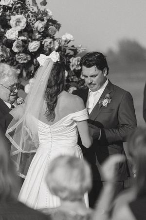 Black and white emotional moment during outdoor wedding ceremony.