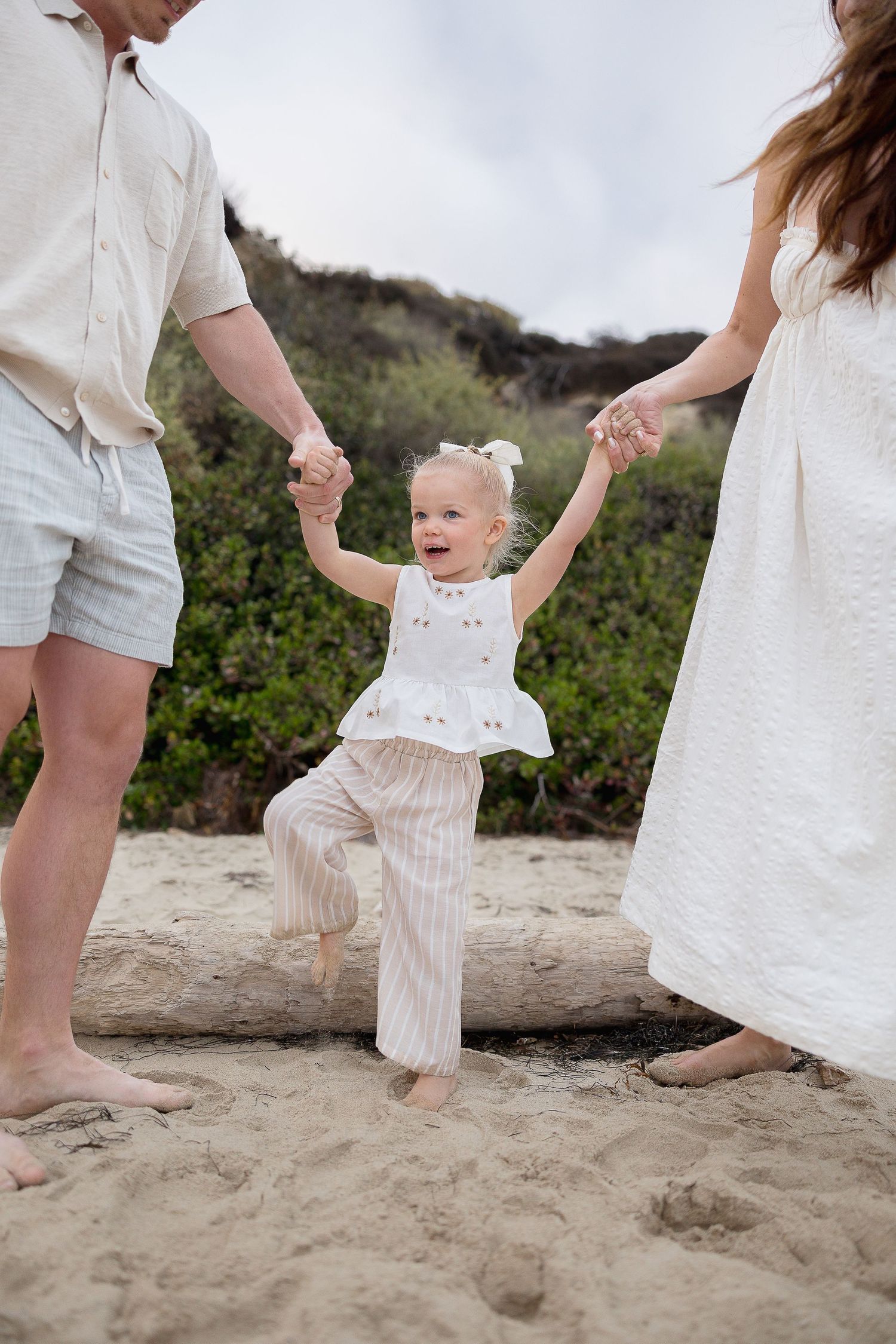 Lifestyle beach family portraits at Crystal Cove with one toddler