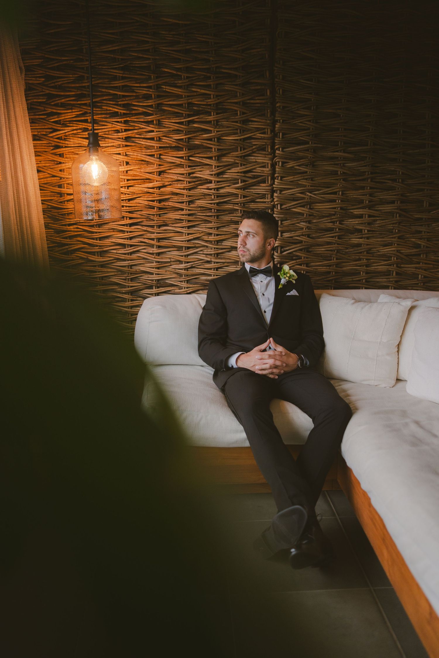 groom looking out window at 1 Hotel Hanalei Bay