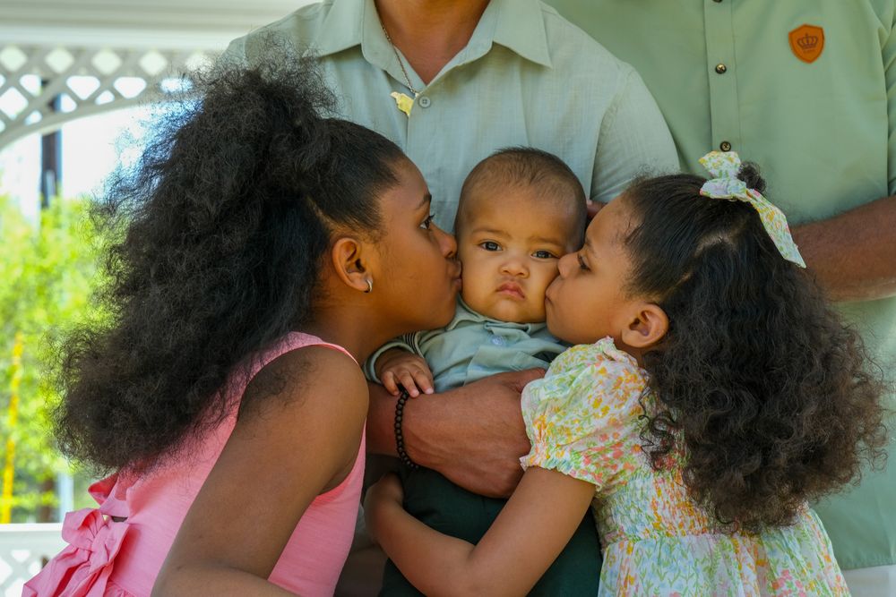Family photography capturing three beautiful young black children. African American family photo session.