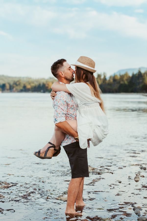 Romantic couple kissing on the beach at Rathtrevor Beach