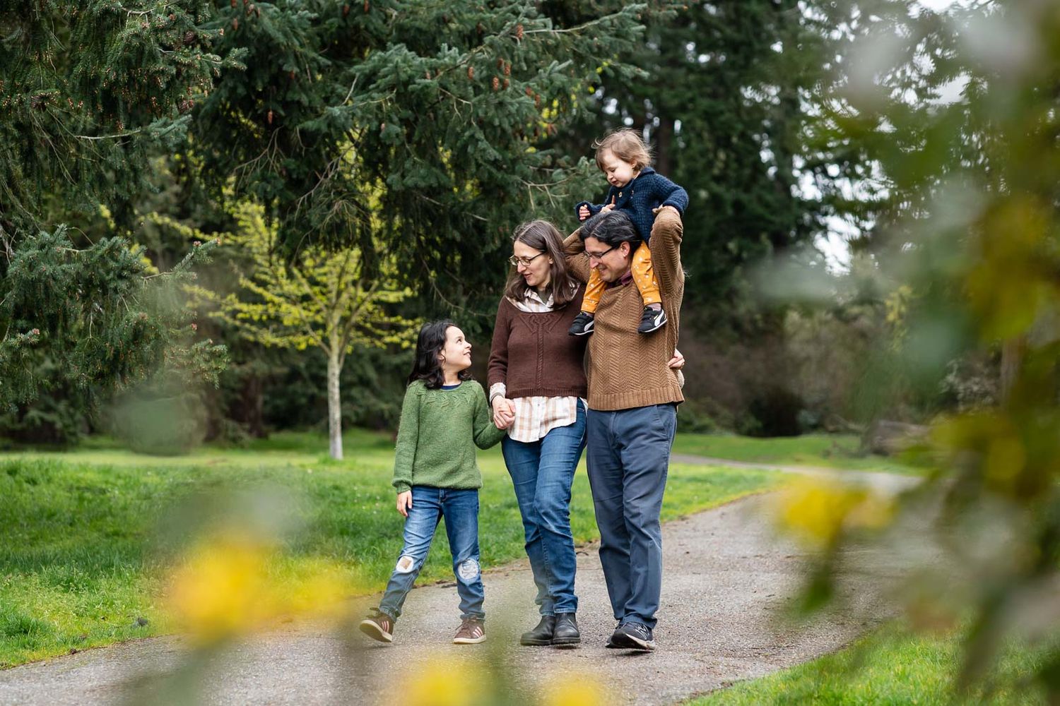Family walking together in a forested path in Lincoln Park.