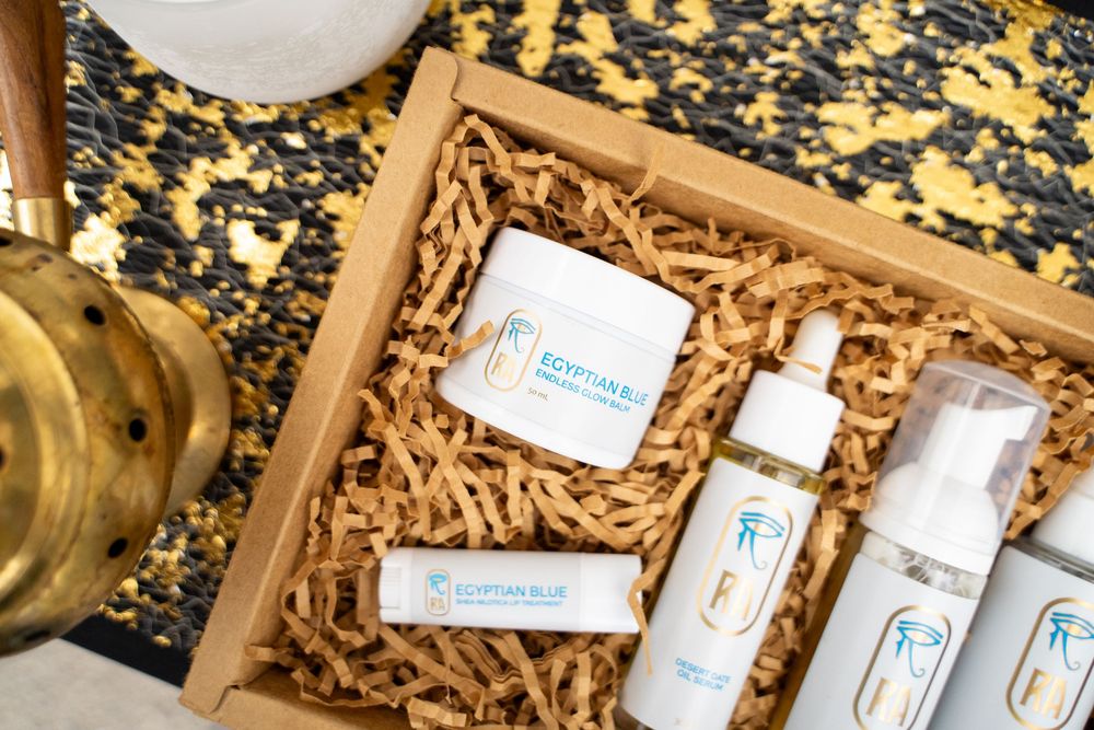 Beauty or wellness products arranged in a decorative box with natural wood shavings.