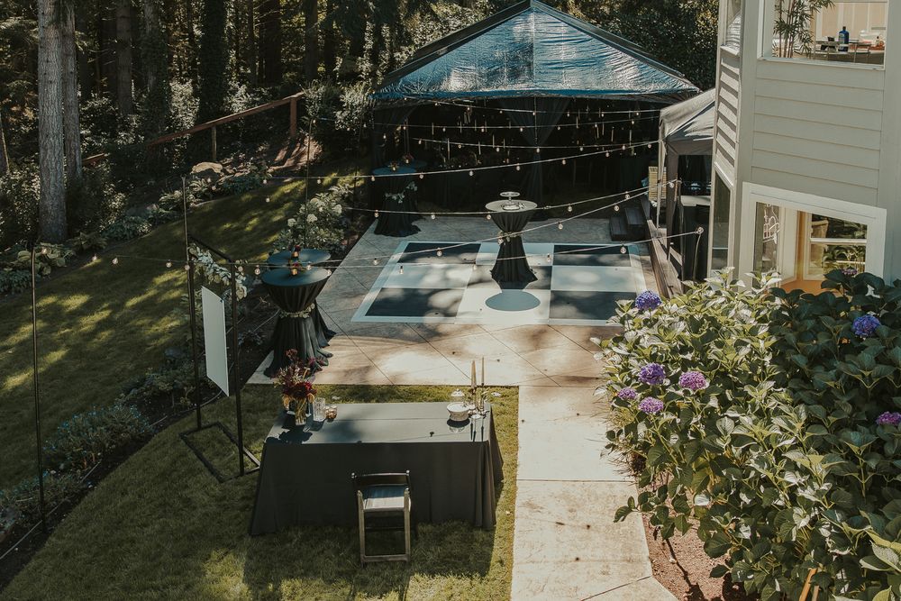 overhead view of checkered dance floor and black wedding tent