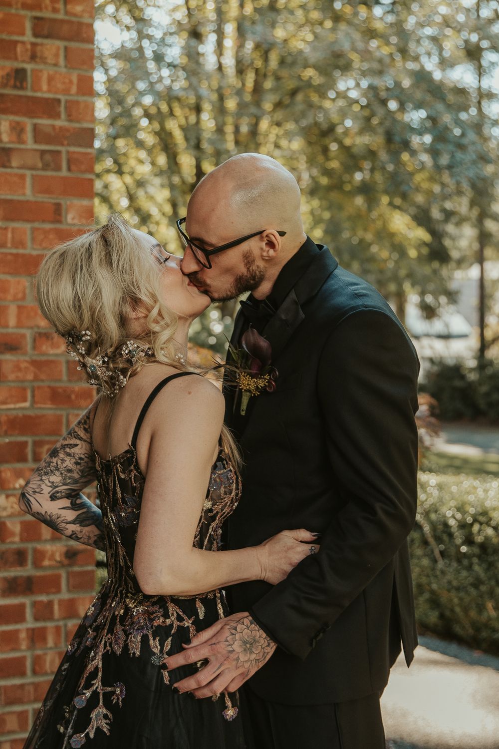 Moody couple portrait with the bride in a gothic lace gown and the groom in a dark suit at a Spokane wedding