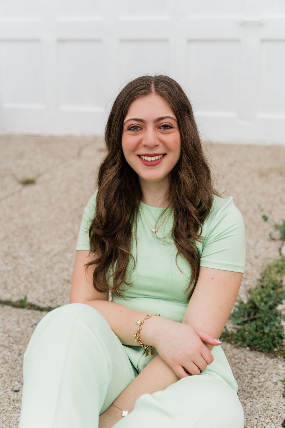A casual portrait against a white background wearing a mint green outfit.