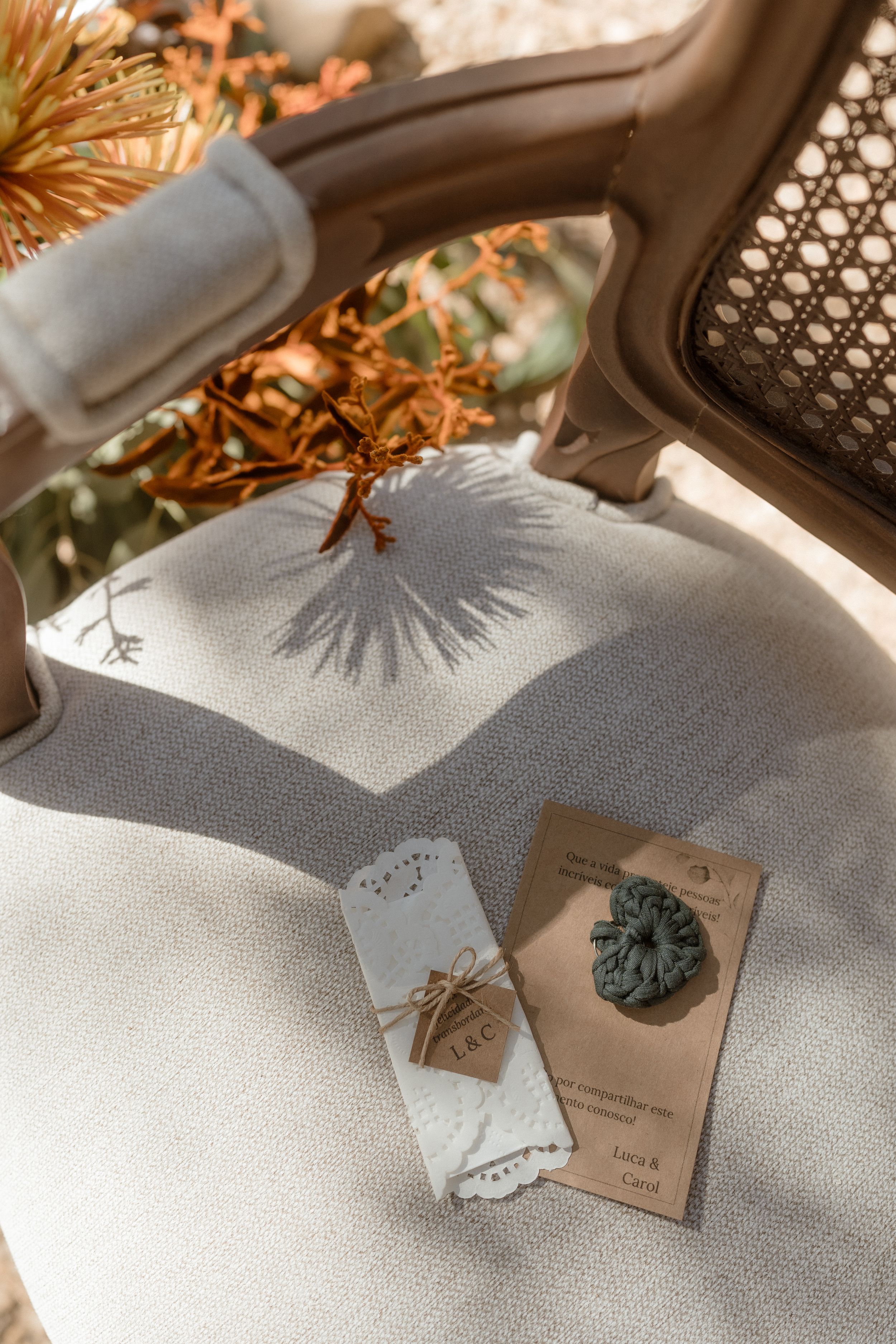 Decorative place cards and table settings with natural elements in warm lighting.