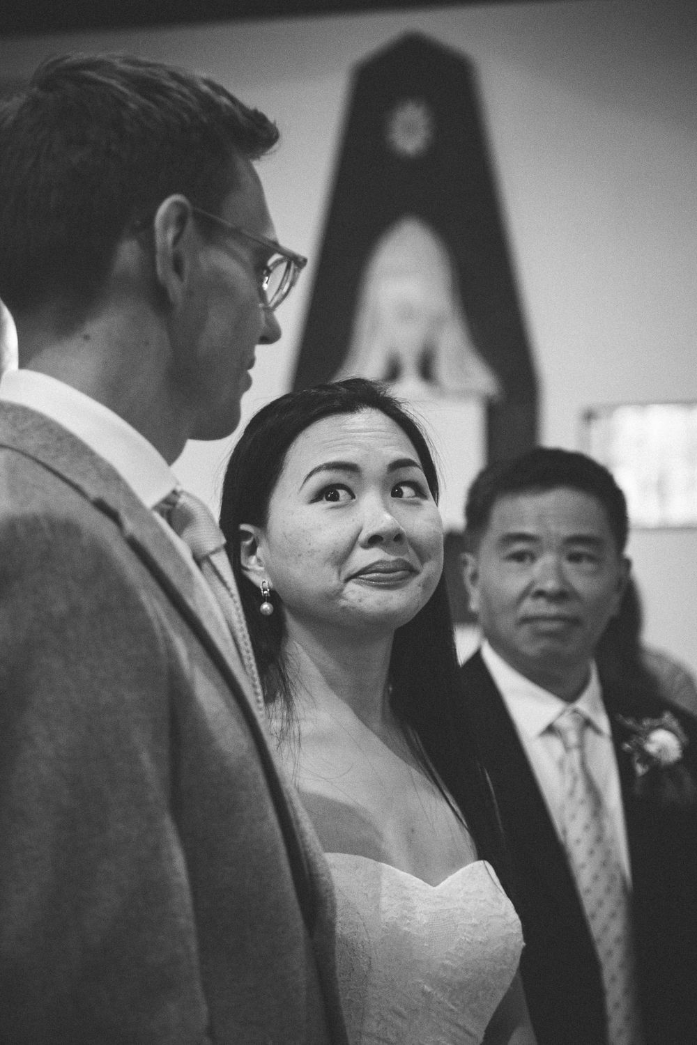 Black and white indoor wedding ceremony candid with Western and Asian fusion styling.