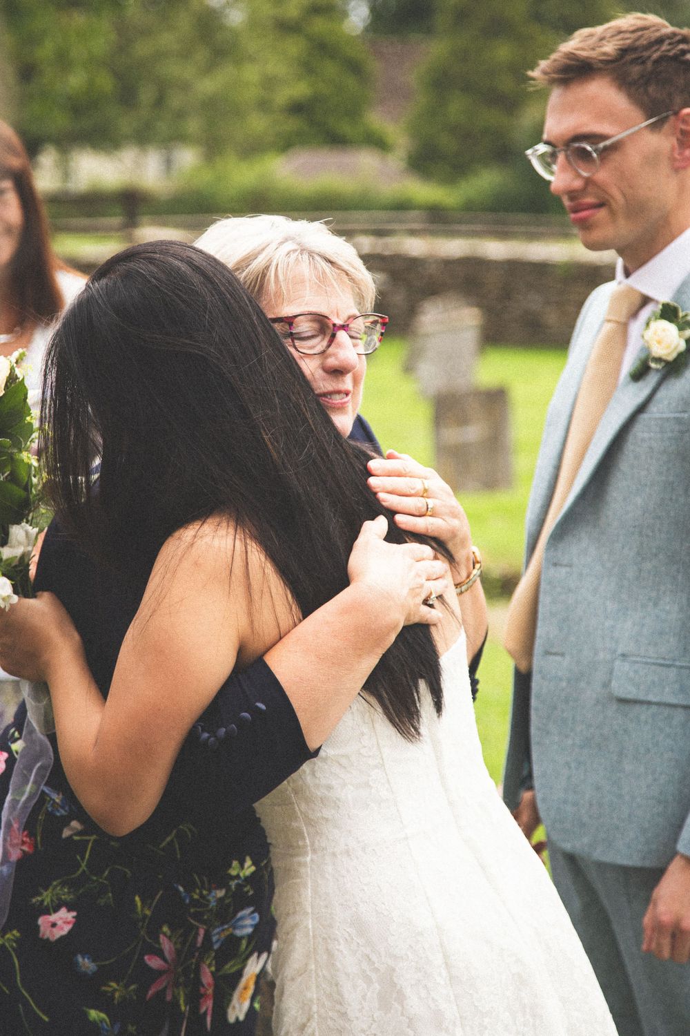 Heartfelt embraces shared during outdoor wedding celebrations.