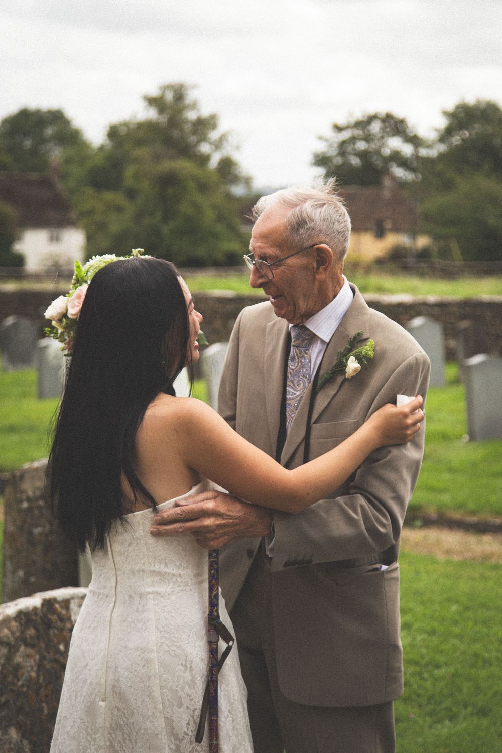 A touching moment shared during wedding celebrations in a garden setting.