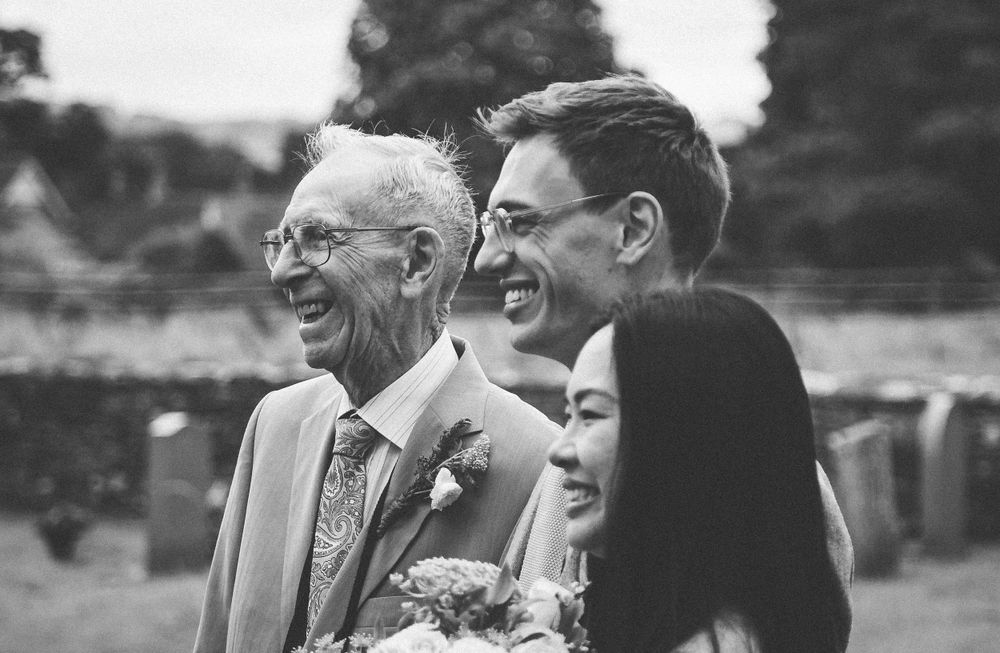 A joyful candid moment captured during wedding celebrations outdoors.