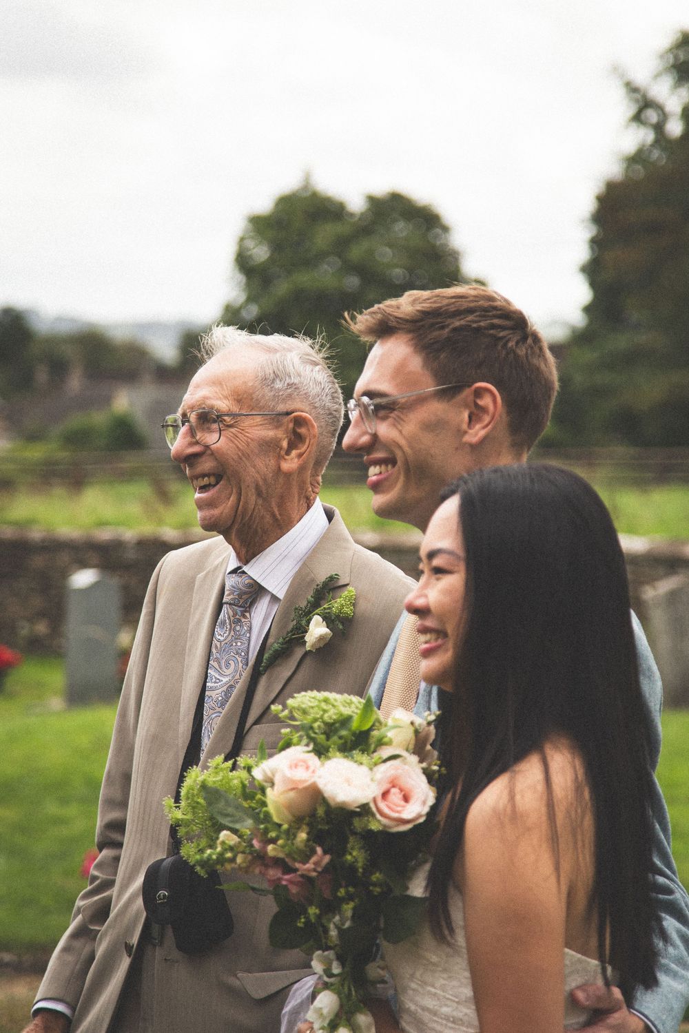 Happy smiles shared during outdoor wedding photographs.