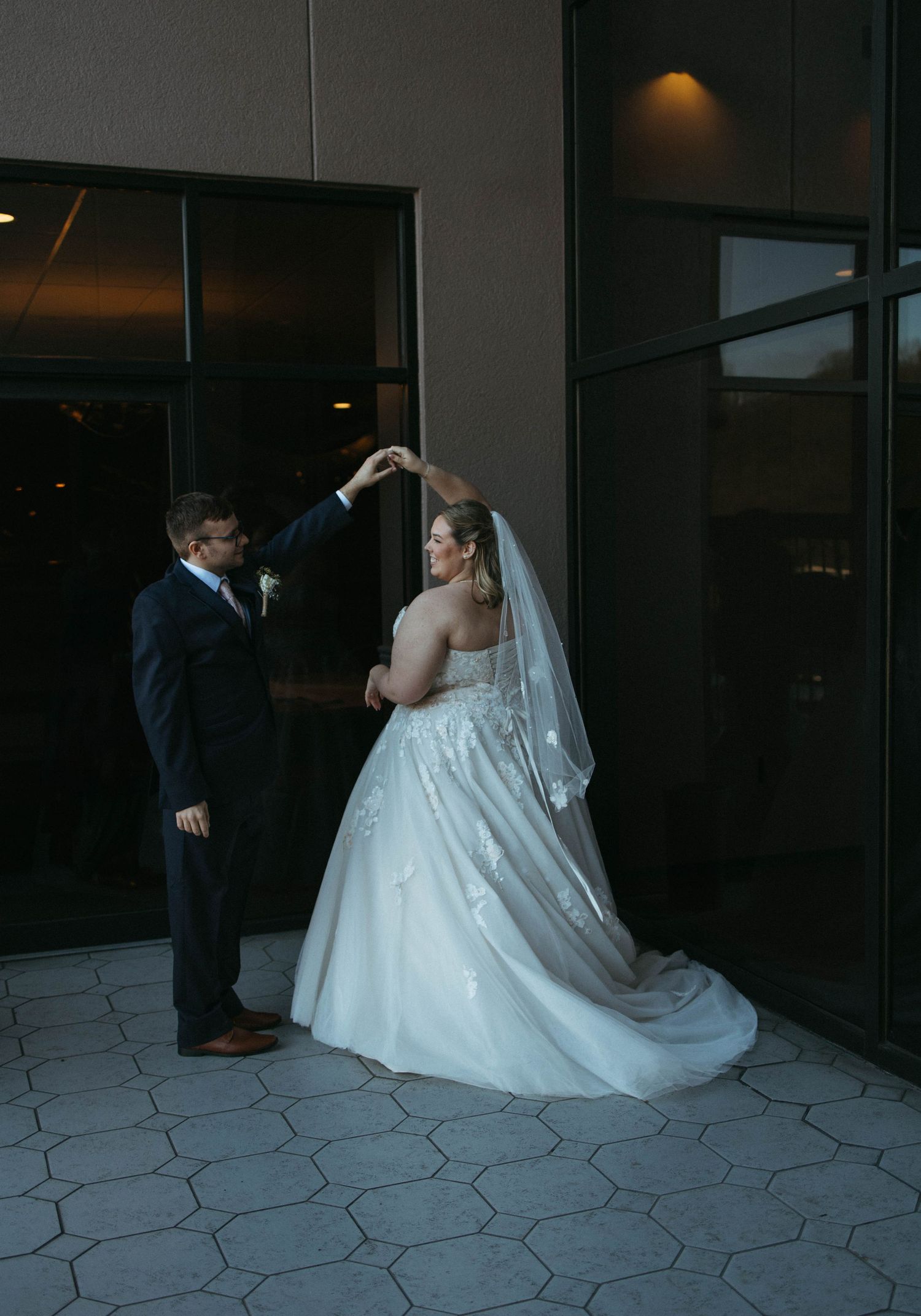 A couple enjoying a romantic dance pose during their wedding photoshoot.