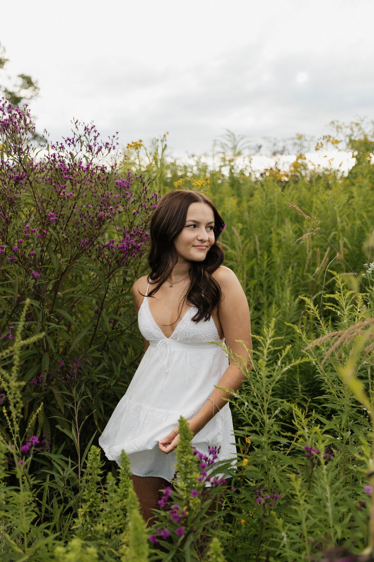 A series of candid outdoor portraits taken in a meadow with vibrant purple wildflowers and lush green vegetation.