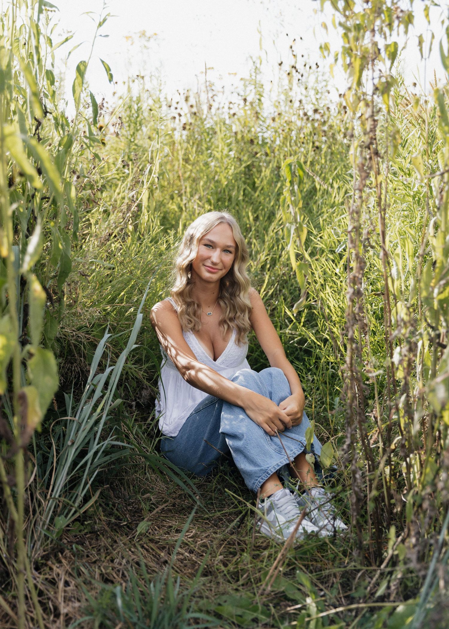 A series of outdoor portrait photos in tall green vegetation with soft natural lighting and rustic styling.
